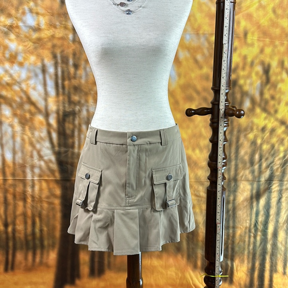 Short pleated tan miniskirt.  Boxy pockets Scout Style